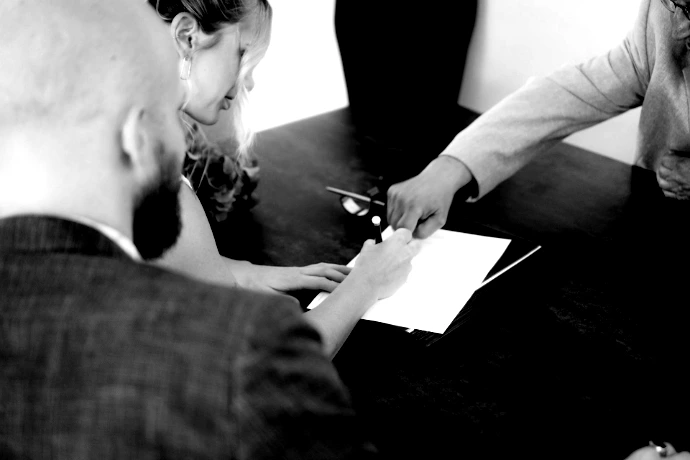couple signing document at desk